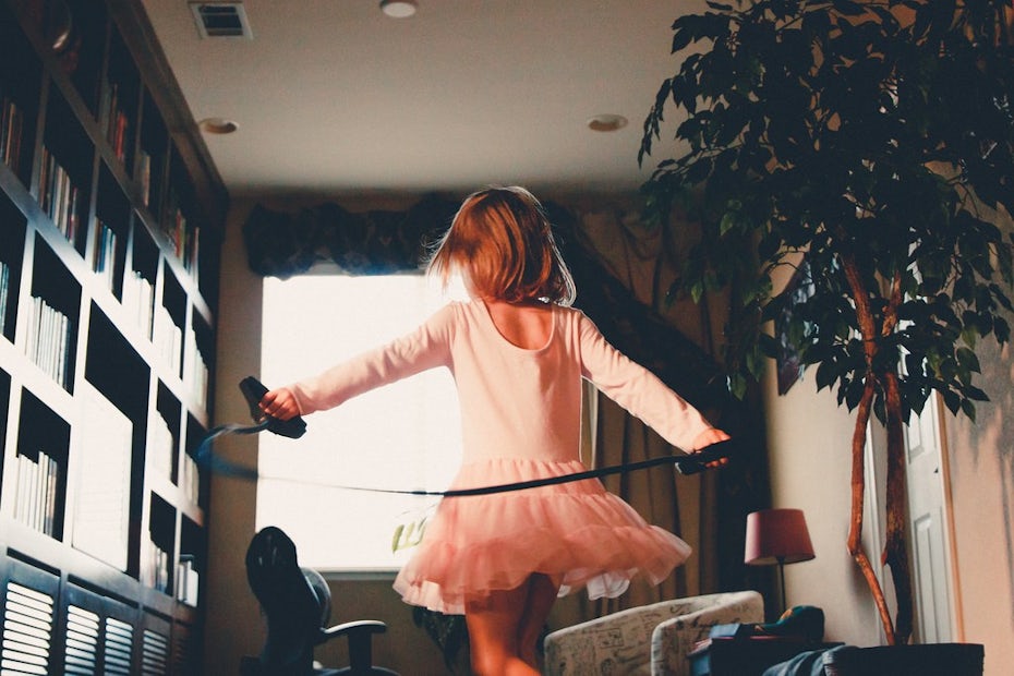A girl in a tutu dancing in a living room
