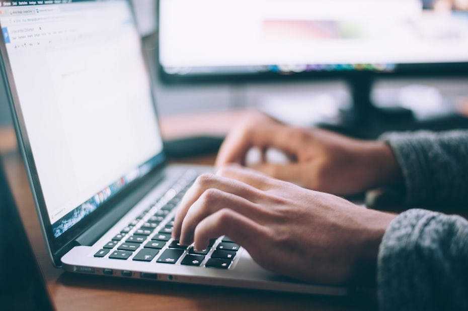 Typing on a laptop keyboard.