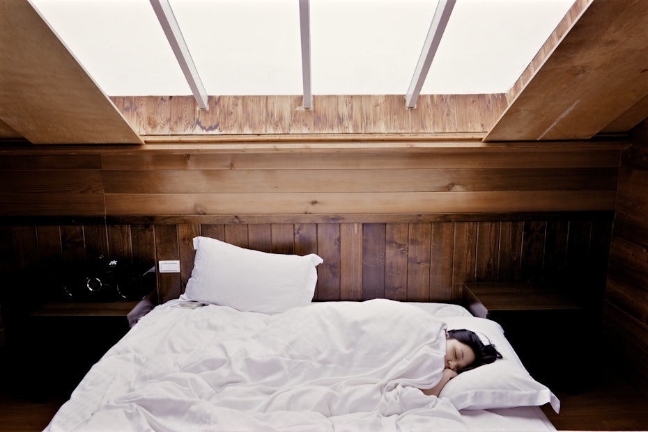 Woman lying in bed during daylight