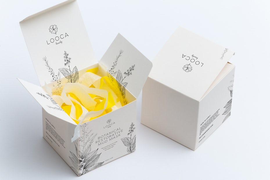 white packaging with intricate floral drawings