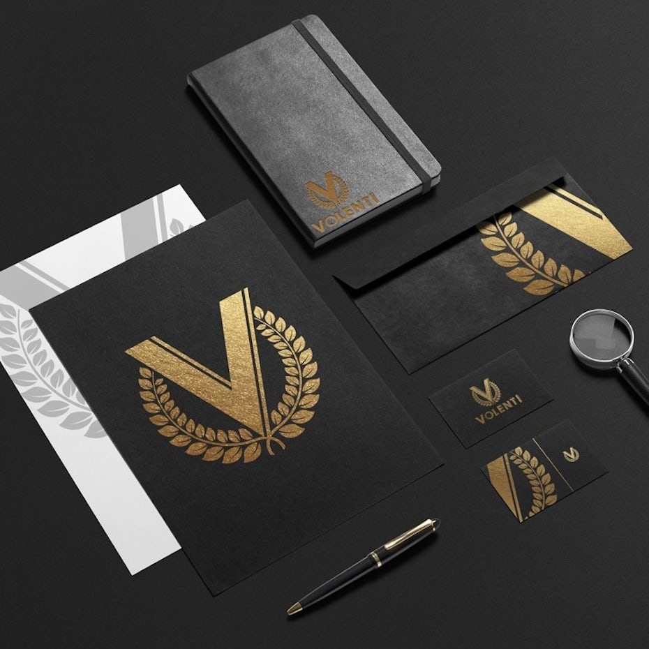 A logo design showing a V in laurels