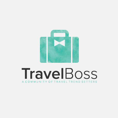 Green suitcase with a bow shape on it