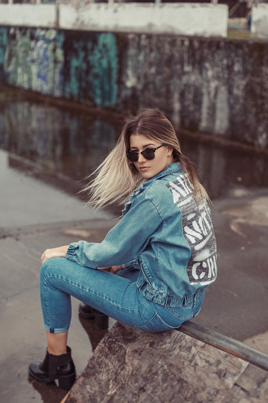 Woman wearing denim jacket and sunglasses