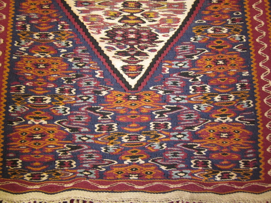 An antique rug with a geometric pattern