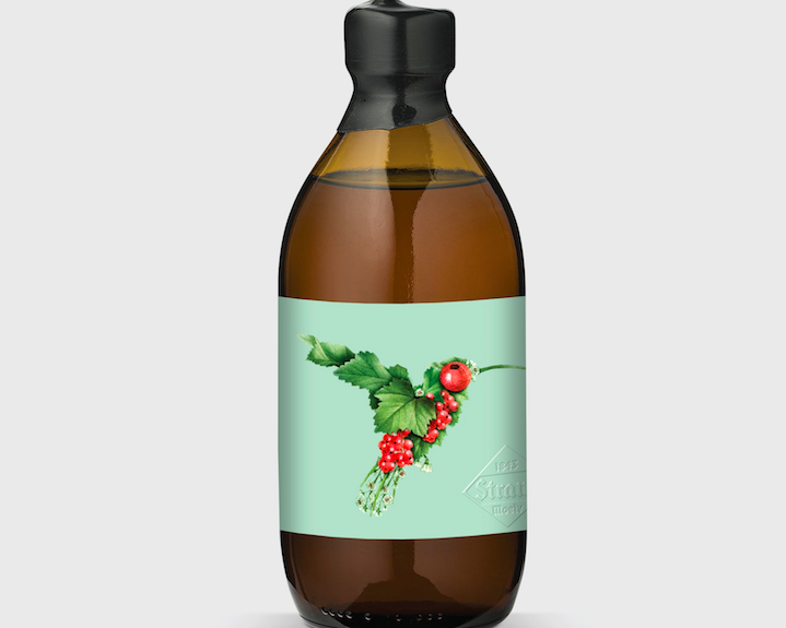 bottle label showing a hummingbird created with smaller images of leaves and berries