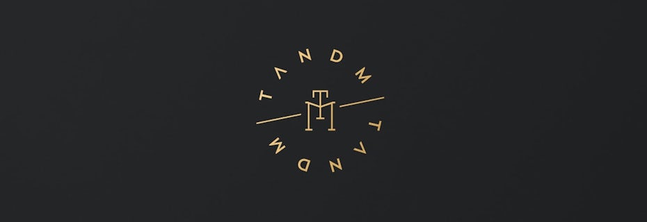 circular gold wordmark business logo against a black background