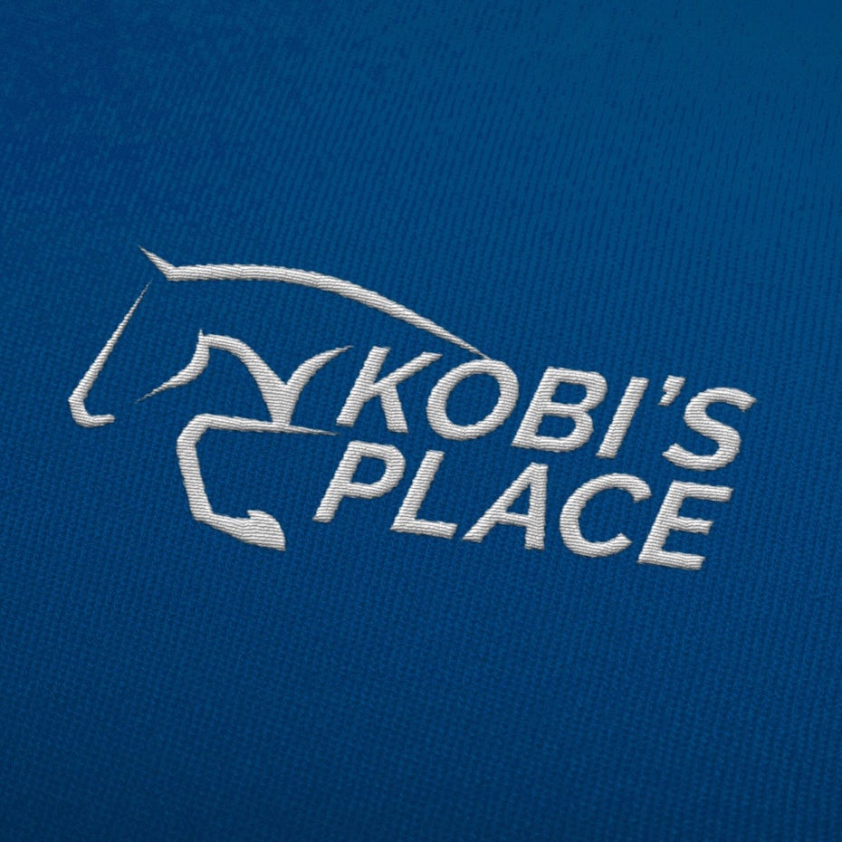 blue background with embroidered white logo of an abstract horse
