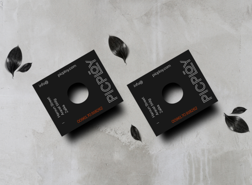 black business card with a hole in the center