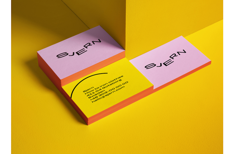 pink and yellow business cards with swoopy text