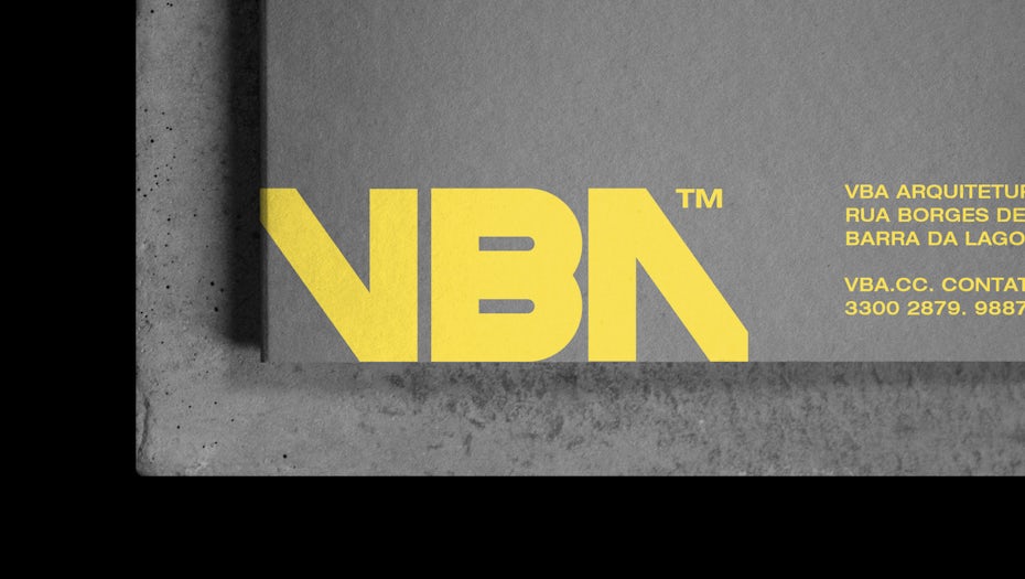 Yellow logo printed on grey marketing materials