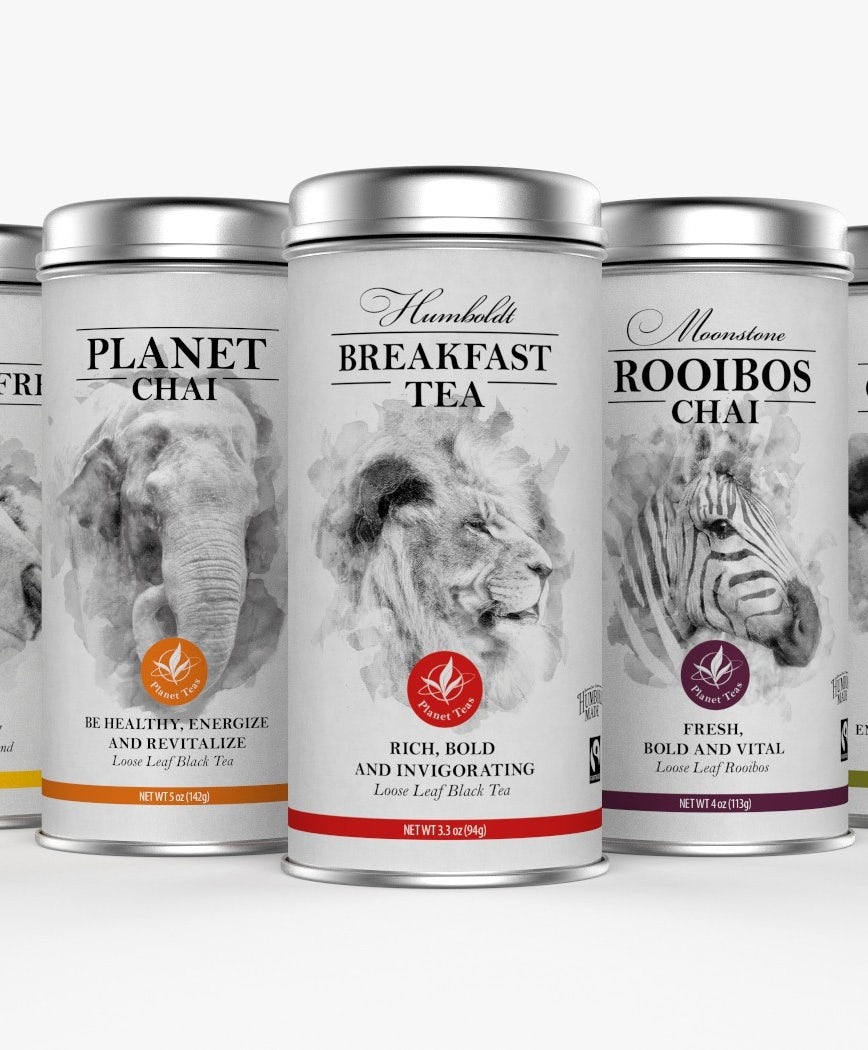 collection of white tea tins, each with a black and white photo of a different animal