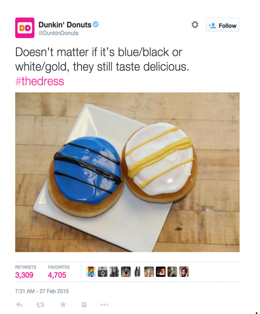 two donuts, one with white and gold icing and the other with blue and black