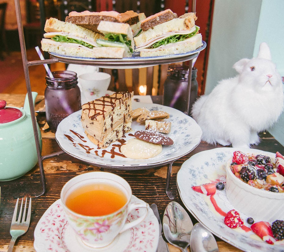 photo of food and tea on a table with a stuffed white rabbit