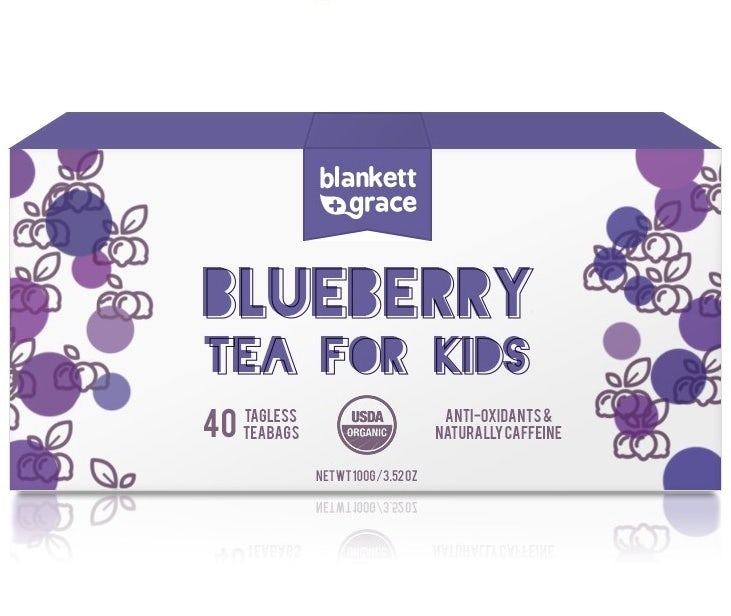 white tea box with purple text and illustrations of blueberries