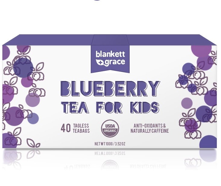 white tea box with purple text and illustrations of blueberries