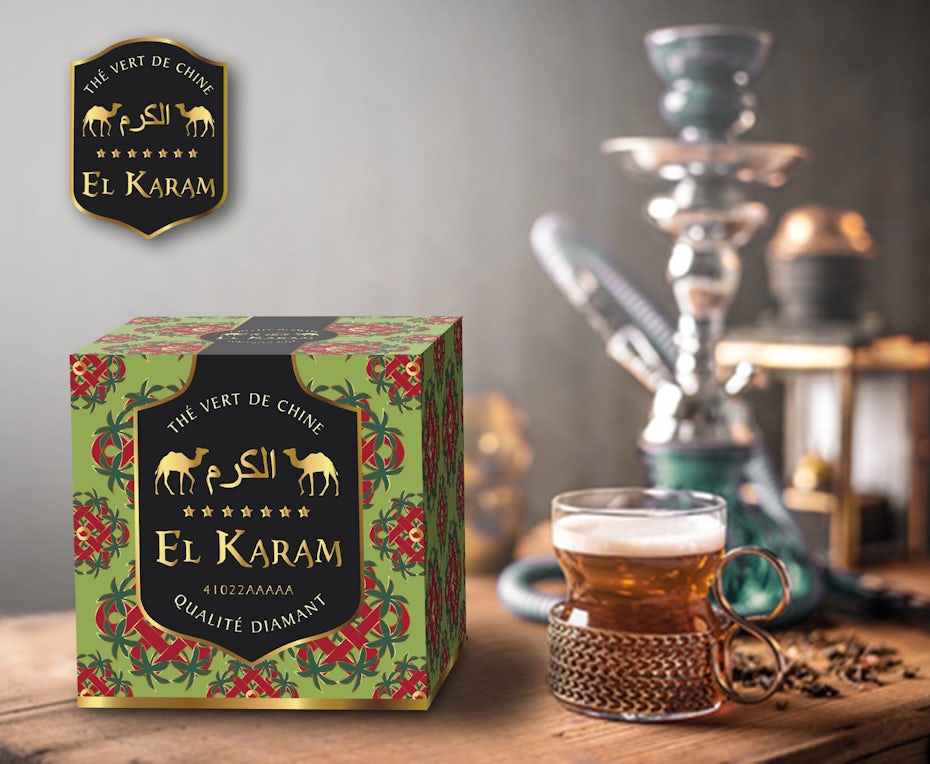 bold patterned tea box beside a hot cup of tea and a hookah