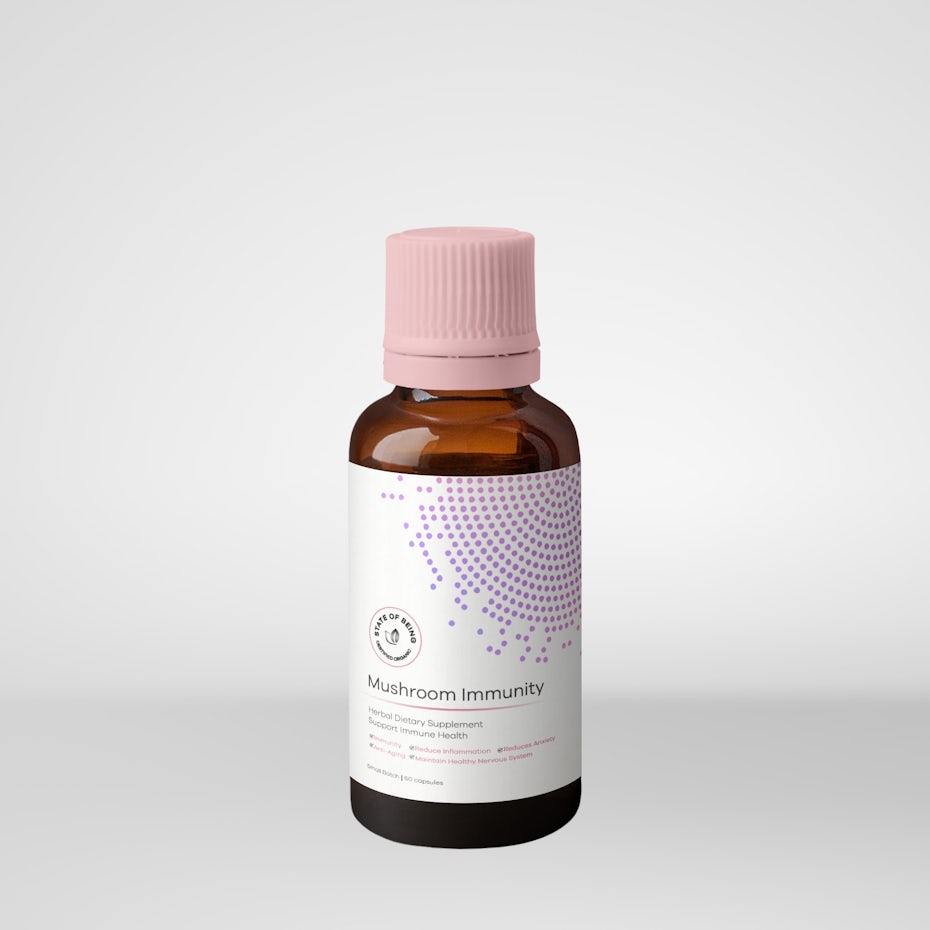 small bottle with a pink cap and geometric dots design on the label