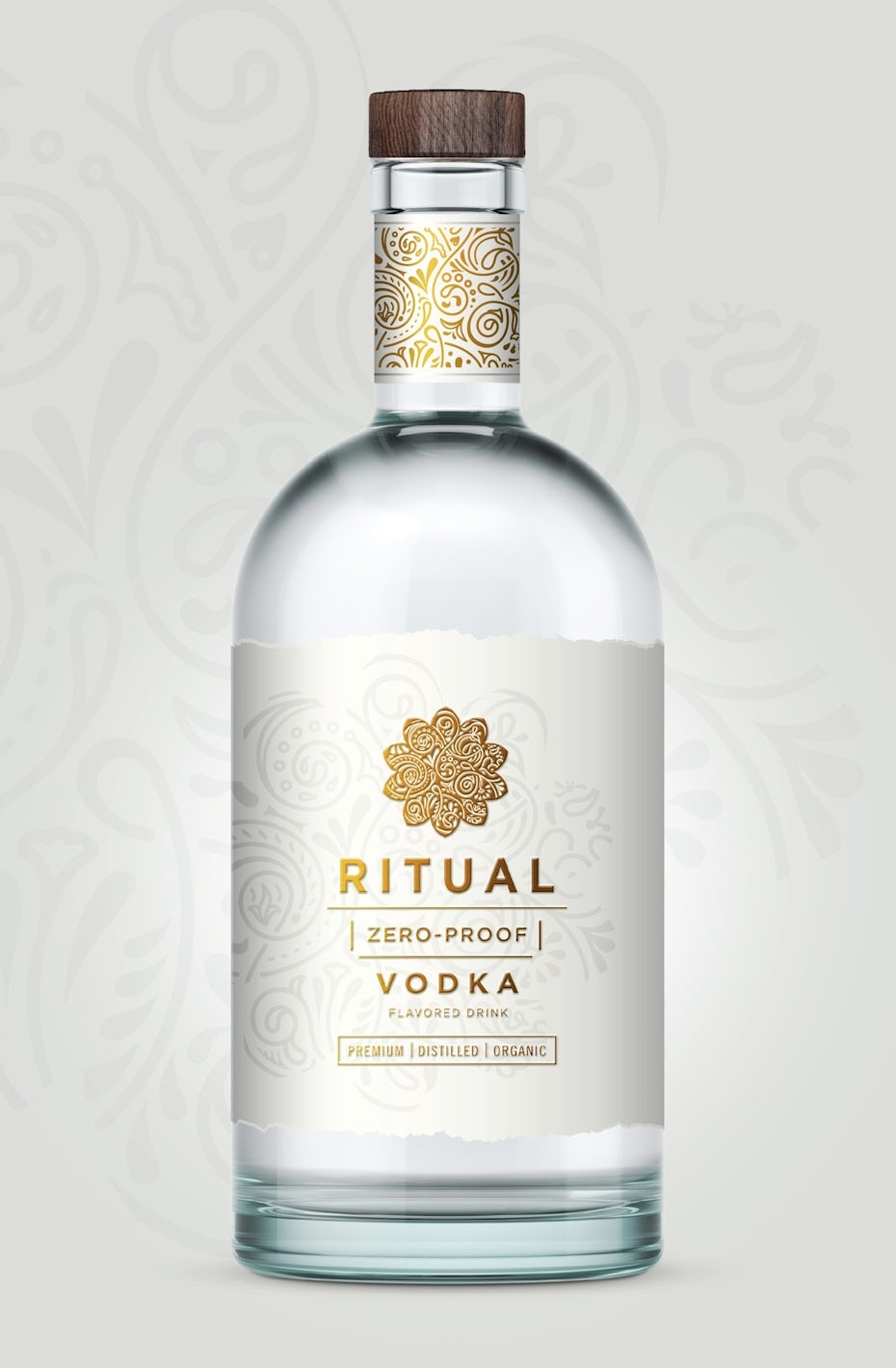 Clear bottle with a white label displaying a geometric gold logo