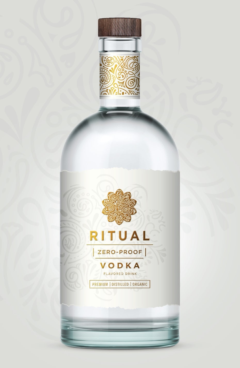 Clear bottle with a white label displaying a geometric gold logo