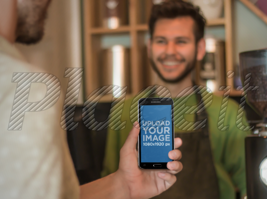 Photo of a man with his back to the viewer and an Android screen facing the viewer