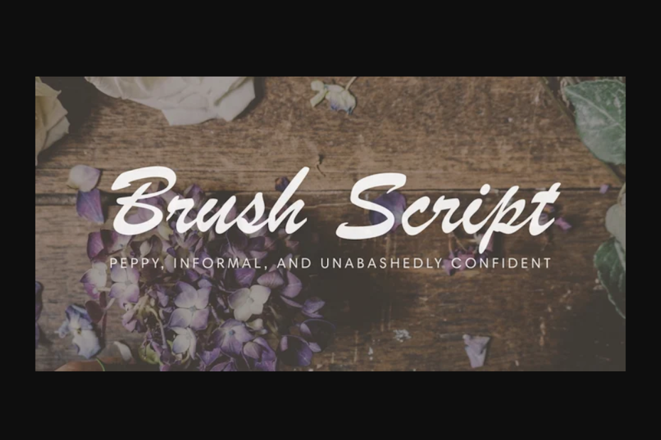 Brush Script font against wooden table background with purple flowers