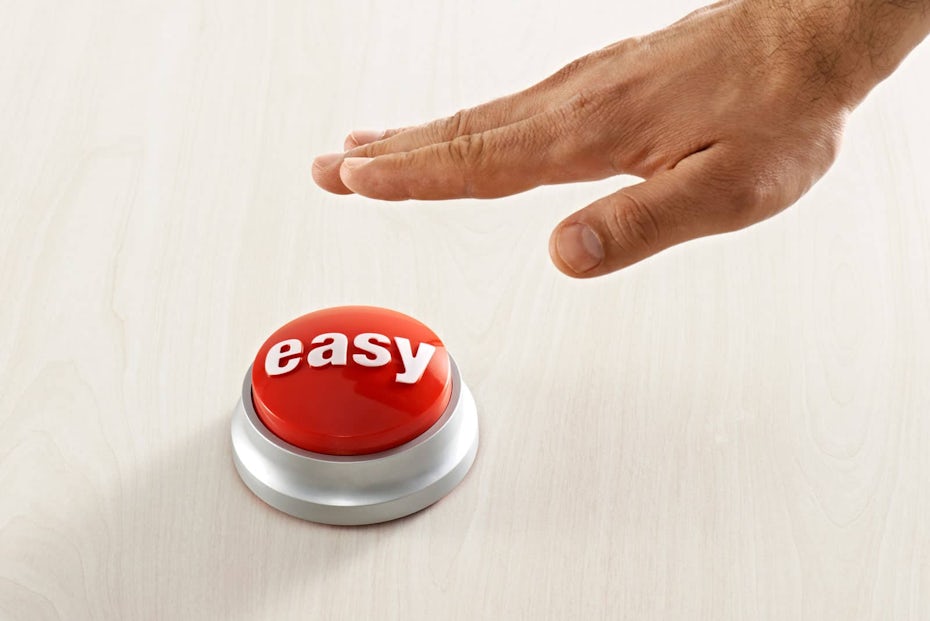 hand reaching for a Staples easy button