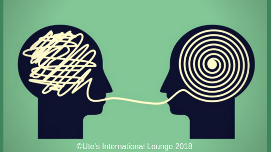 two silhouette heads, one with a spiral inside it and the other tangles inside