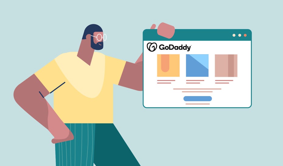 Person holding up a website made by GoDaddy