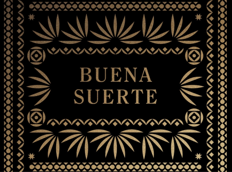 a brown and gold card with the text buena suerte