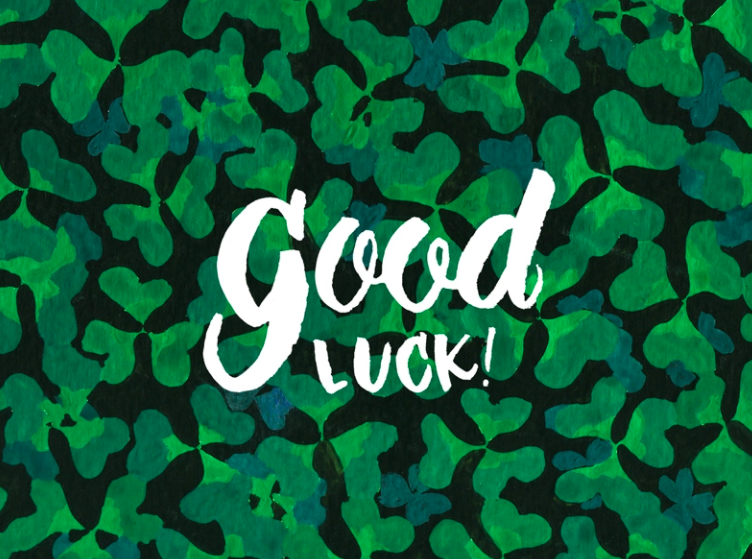 a green card with the text good luck