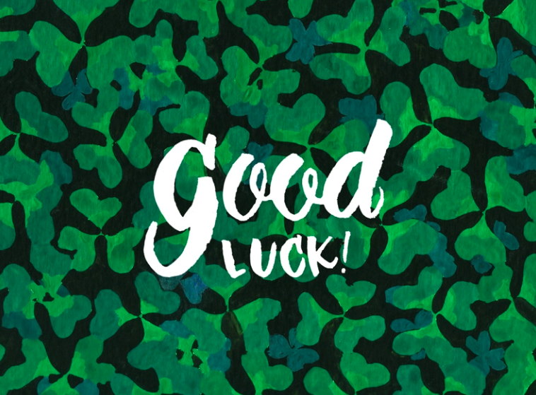 a green card with the text good luck