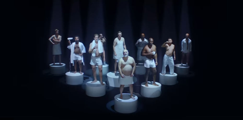 Ten half-naked middle-aged men standing on separate white platforms.