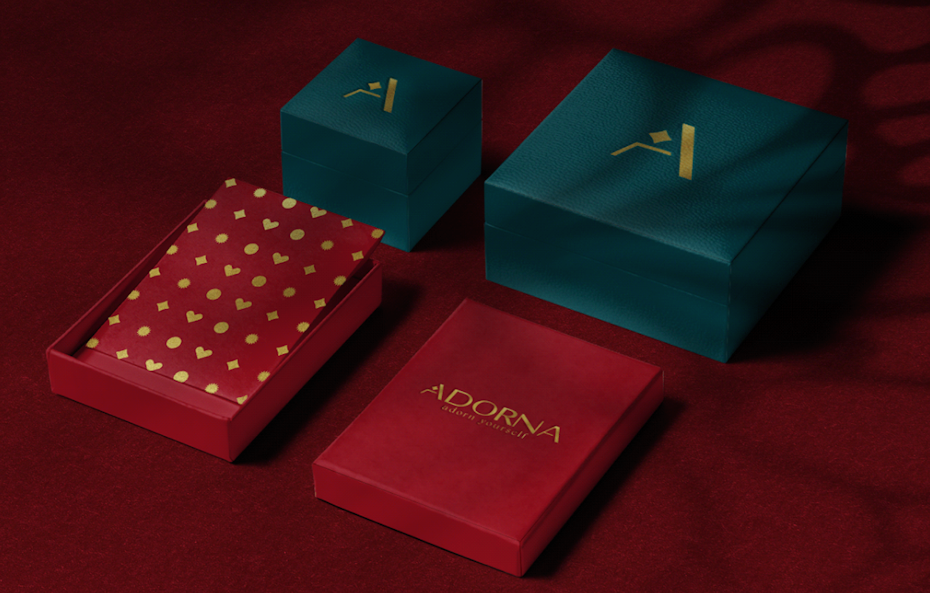 closed and open green boxes, plus a floral bag, for gold jewelry