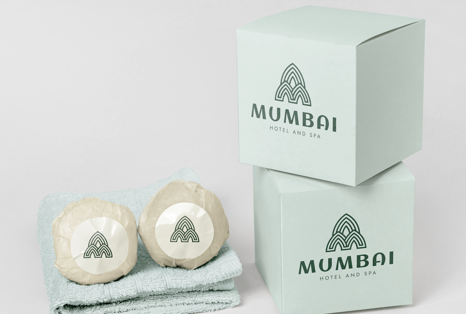 towels, wrapped soaps and green boxes showing triangular logo