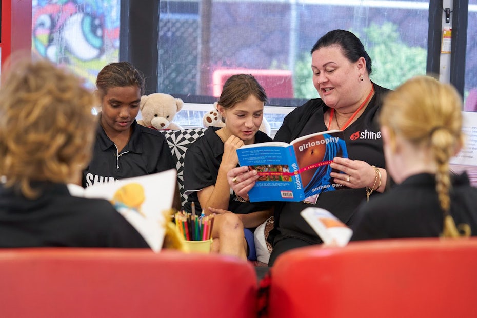 group of girls together with someone reading with them