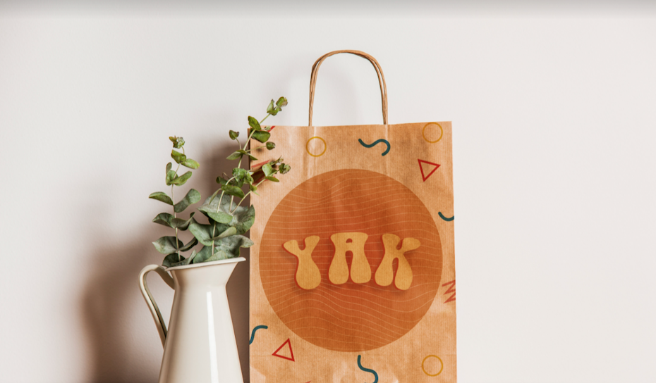 brown paper bag with round orange striped logo