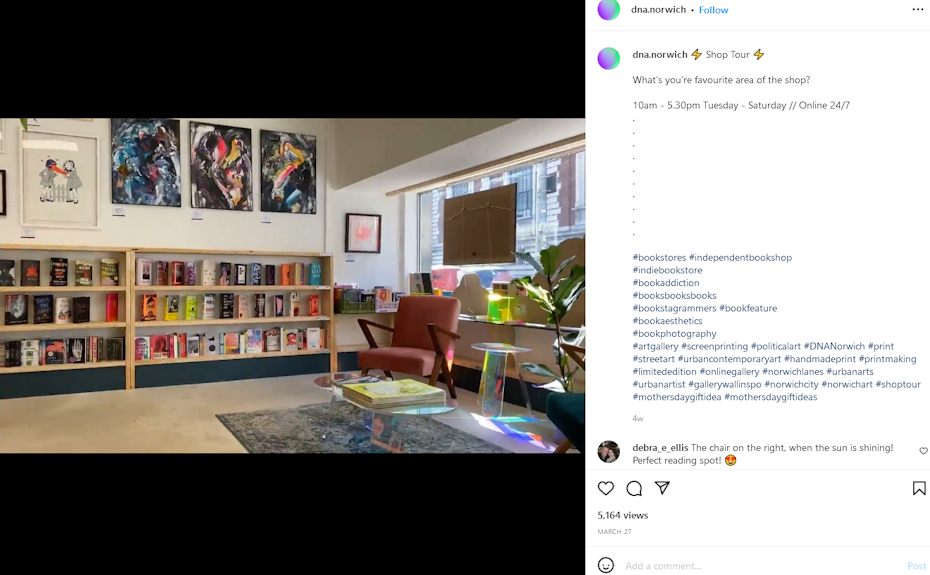 An orange reading chair with shelves of books in the background
