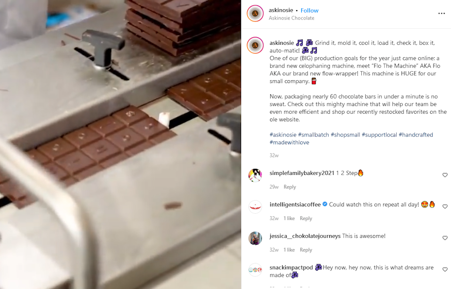 A stack of chocolate bars are processed by a machine