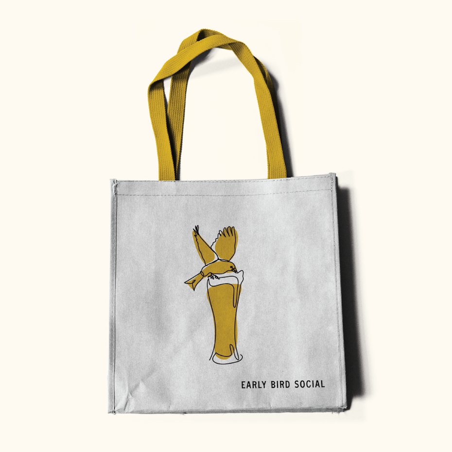 tote bag with illustration of bird drinking out of glass