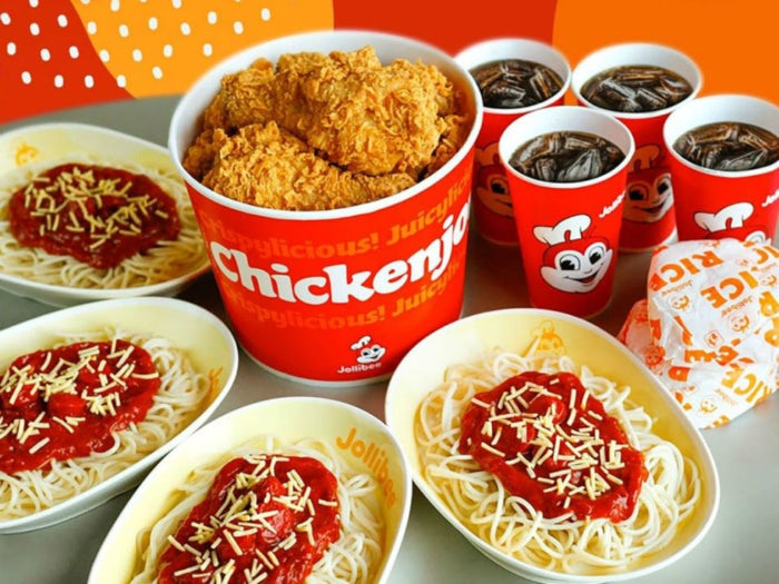 photo of Jollibee products, a bucket of chicken and spaghetti servings and soft drinks