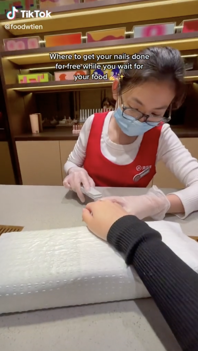 A short clip of Haidilao staff offering a full-service nail spa