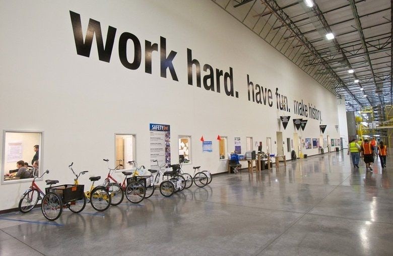 An office wall with the words “Work hard. Have fun. Make history.”