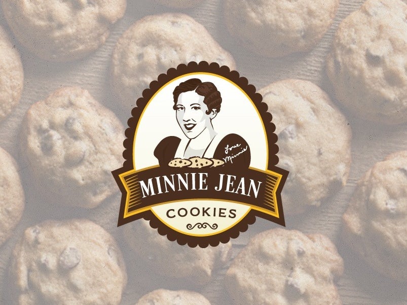 brown and white image of a woman looking at the viewer, right above a plate of cookies