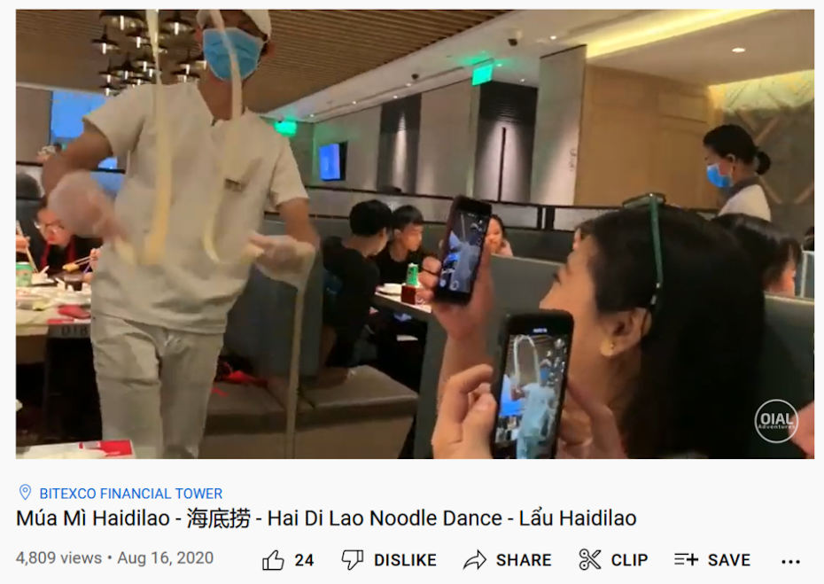 A noodle master handmakes fresh noodles while performing in front of the diners