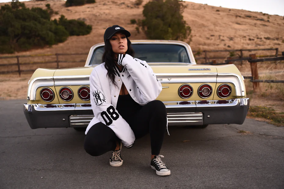 Photo of a model in front of a lowrider car, brand image for Cukui