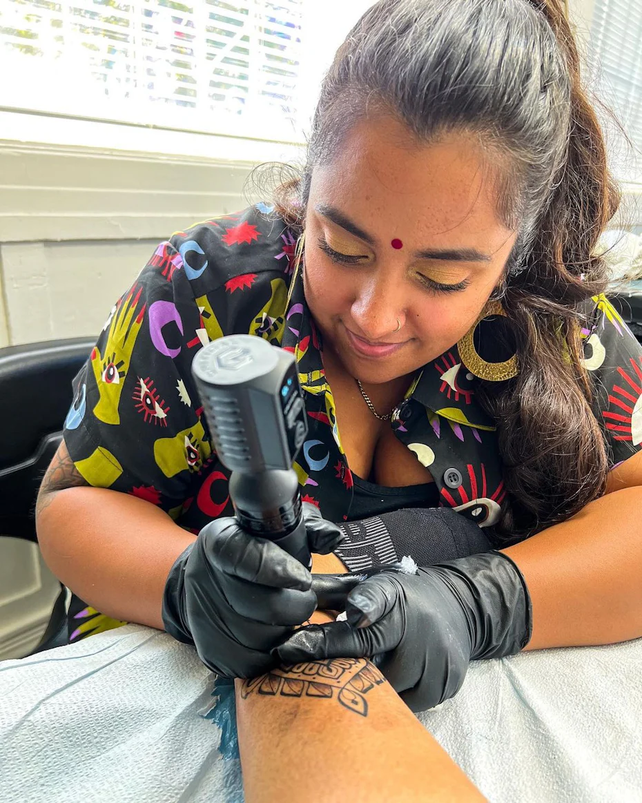 Photo of Ritual by Design founder Sabreena Haque doing a permanent henna tattoo on a client