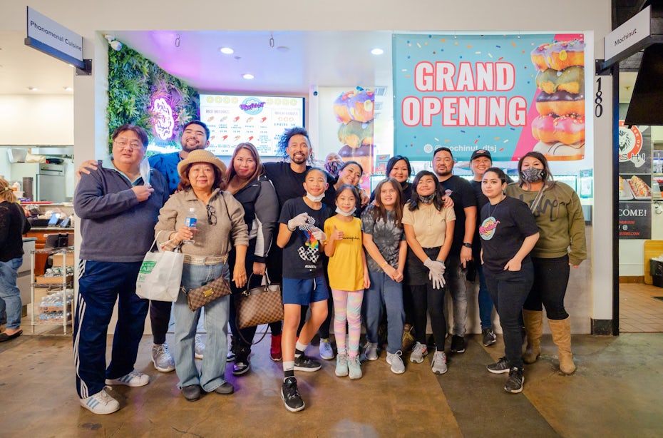 photo of a bunch of friends and family standing in front of mochinut on grand opening day
