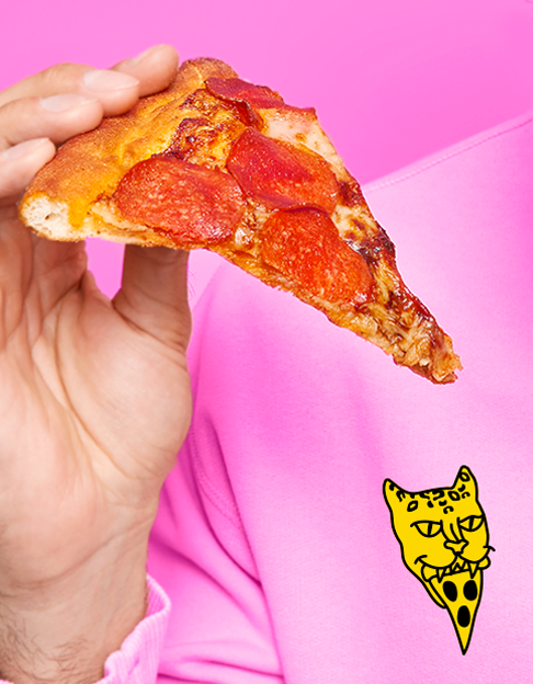 a photo of a person holding a pizza wearing a bright pink shirt