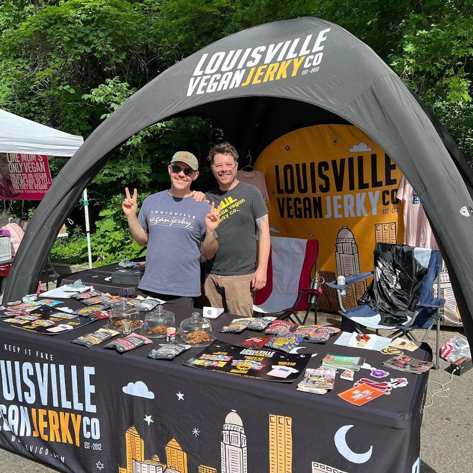 a booth tent with louisville vegan jerky products